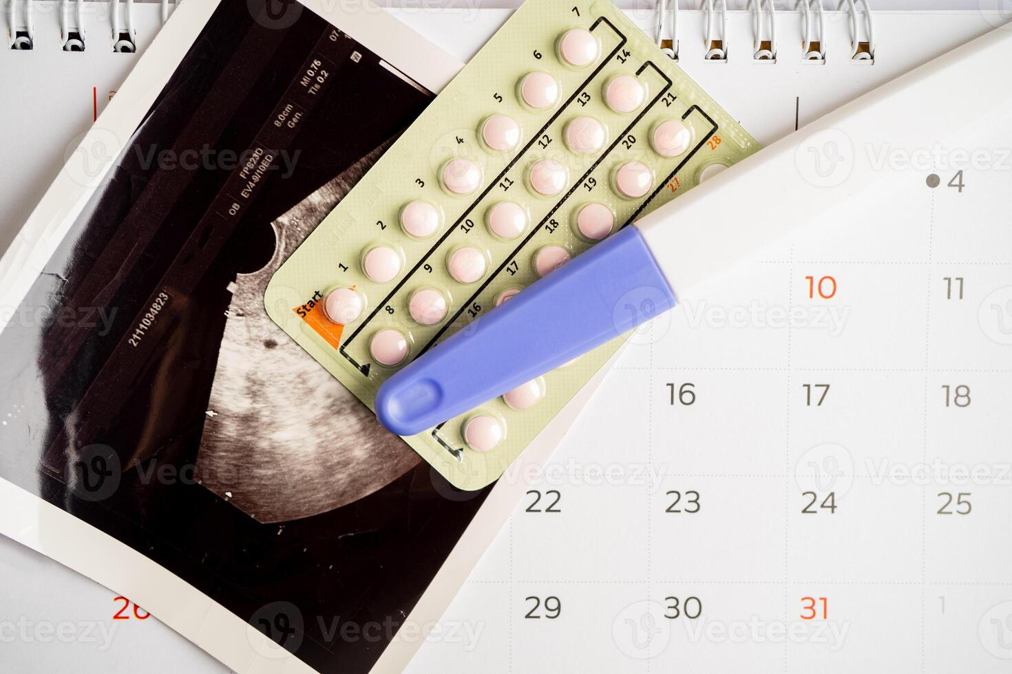 Pregnancy test and birth control pills with ultrasound scan of baby uterus, contraception health and medicine. photo