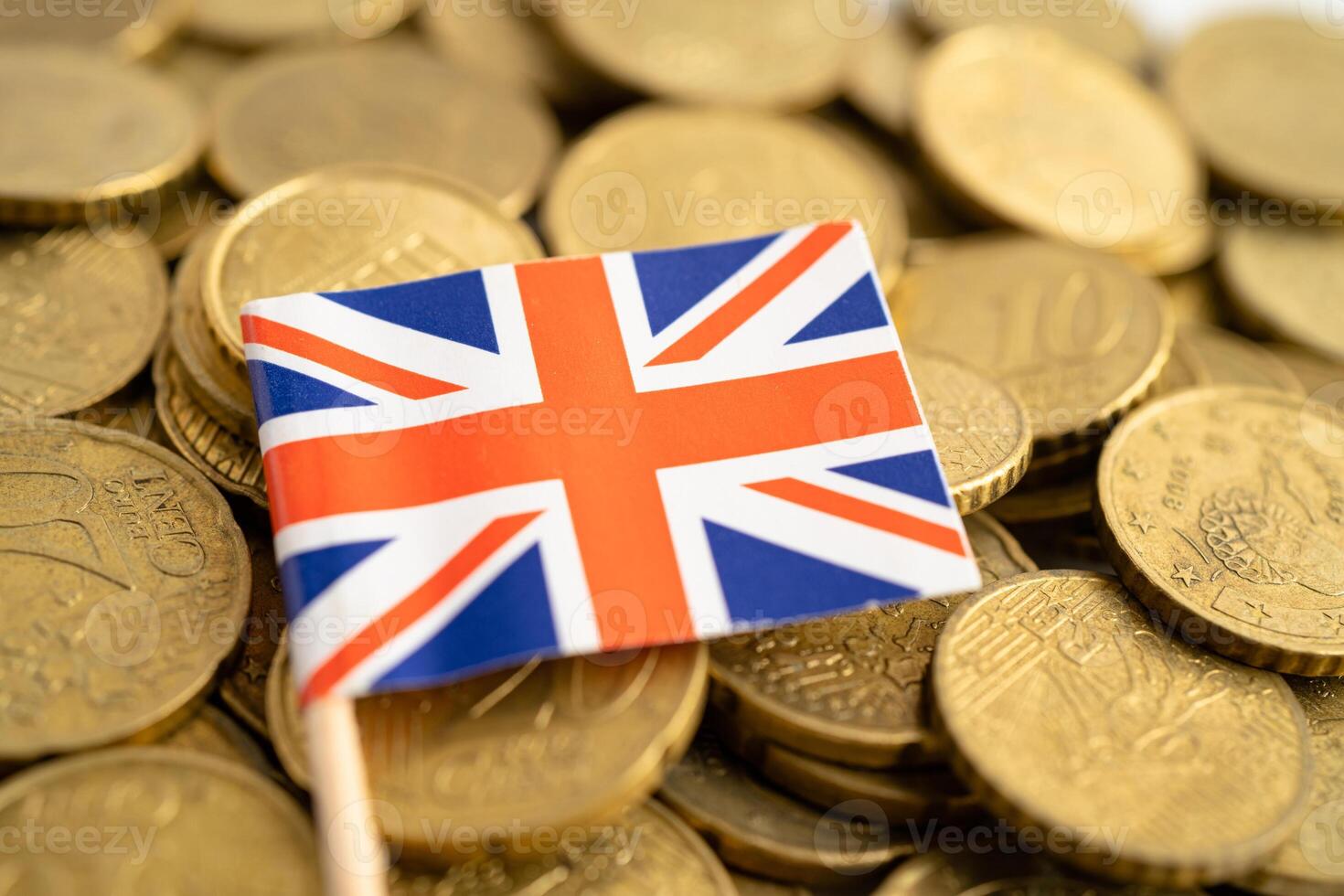 United Kingdom flag on coins money, finance and accounting, banking concept. photo