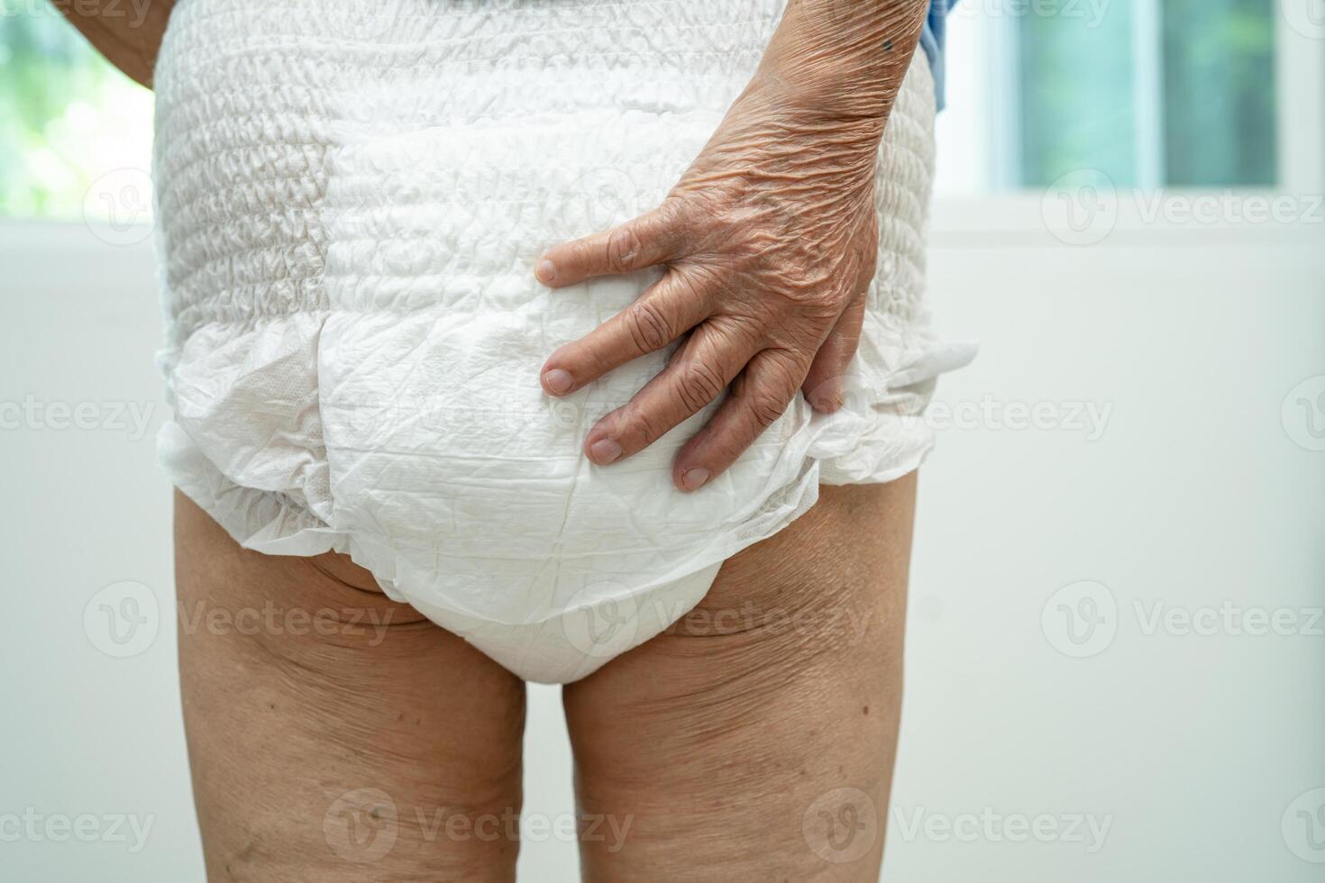 Asian senior woman patient wearing incontinence diaper in hospital, healthy strong medical. photo