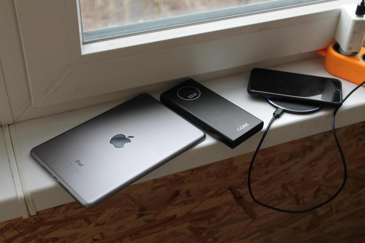KYIV, UKRAINE - February 21, 2024 Charging an Apple smartphone, wired or wireless photo