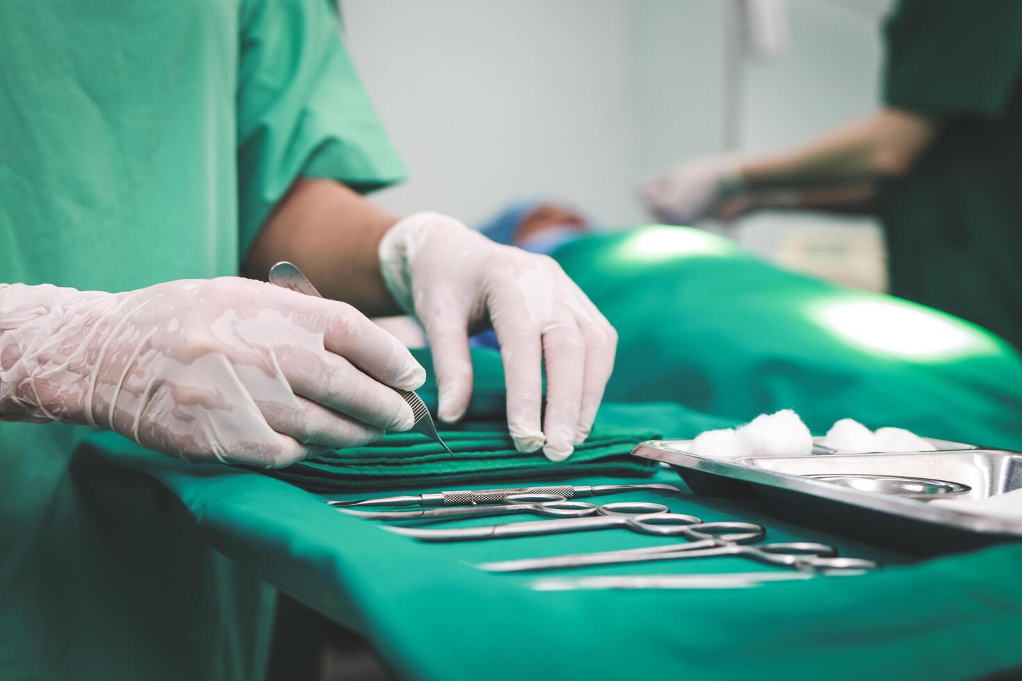 Professional team of Asian surgeons Perform surgery on a patient lying on a bed in a hospital operating room. Medical concepts. emergency surgery photo