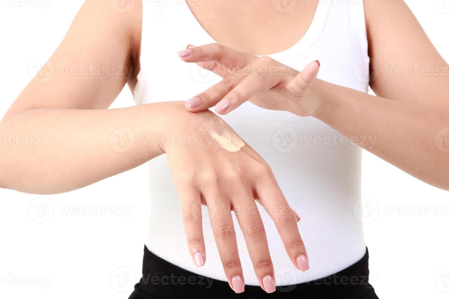 Young Asian women apply skin cream on their arms to enhance their beauty. She takes care of her skin health to be smooth, bright, healthy, natural. beauty concept Health care. White background. photo