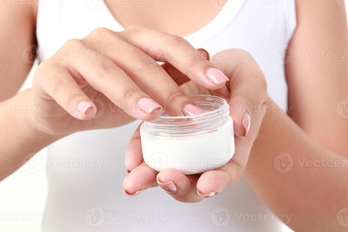 Young Asian woman holding a jar of cream to apply her skin. Enhance beauty and health care for smooth, bright, healthy, natural skin. beauty concept Health care. White background. photo