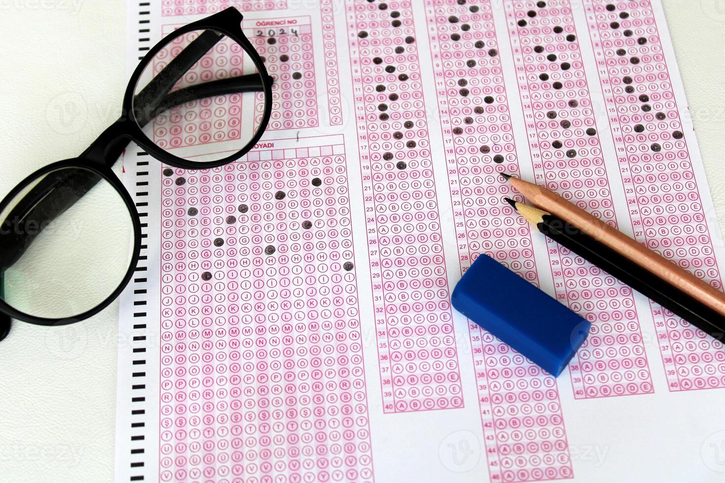 Optical reader, pencil, glasses, and eraser on it. Exam, idea conspet. Future Anxiety. Uncertainty. Multiple choice exam.Adults taking the exam. photo