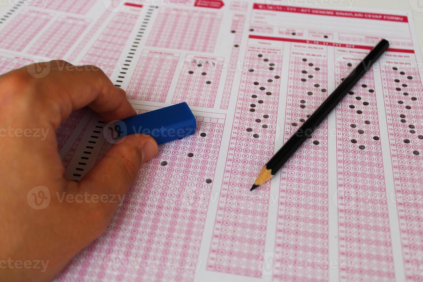 Exam, a hand taking a test with a pencil over an optical reader. Future Anxiety. Uncertainty. photo