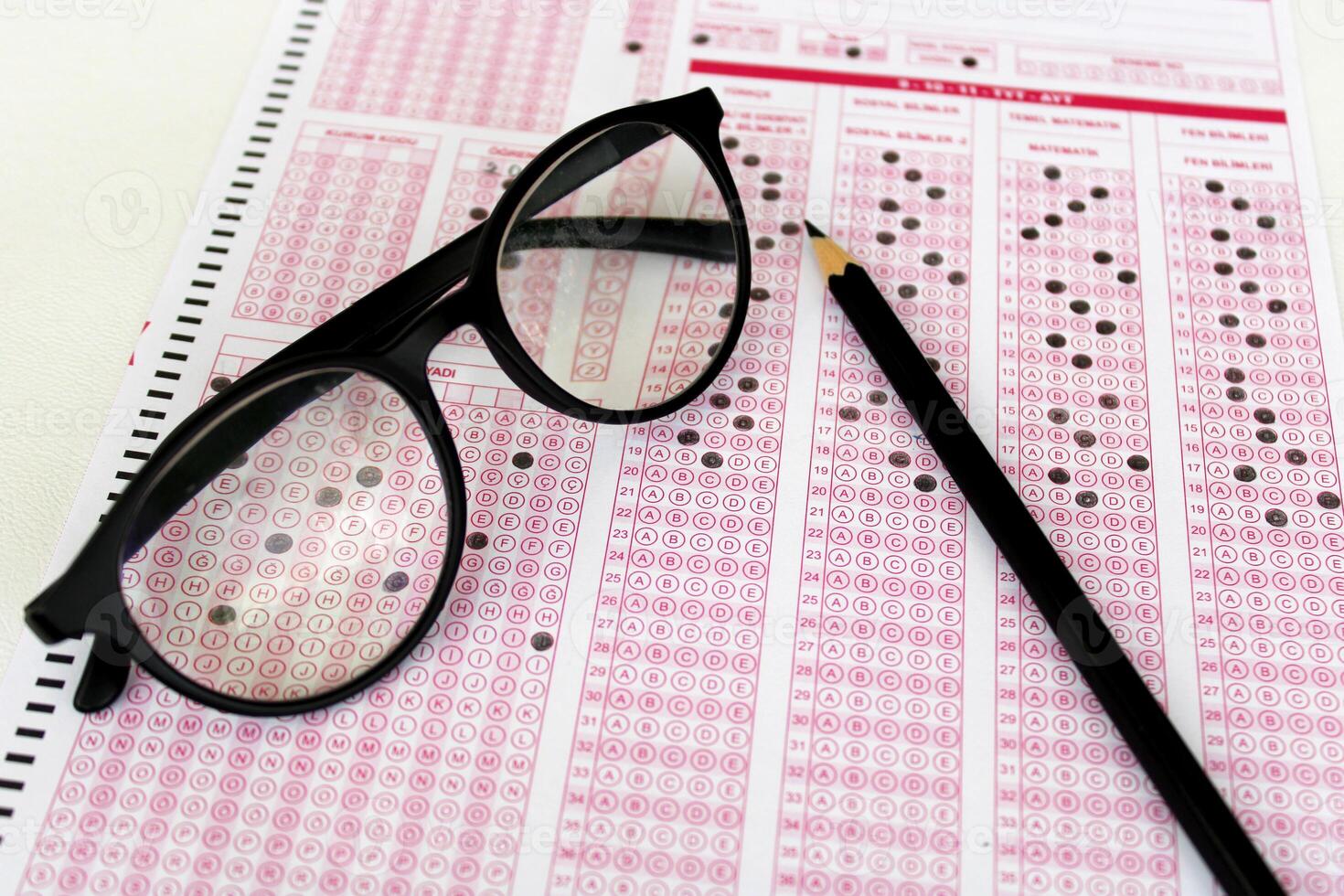 Optical reader, pencil, glasses, and eraser on it. Exam, idea conspet. Future Anxiety. Uncertainty. Multiple choice exam.Adults taking the exam. photo