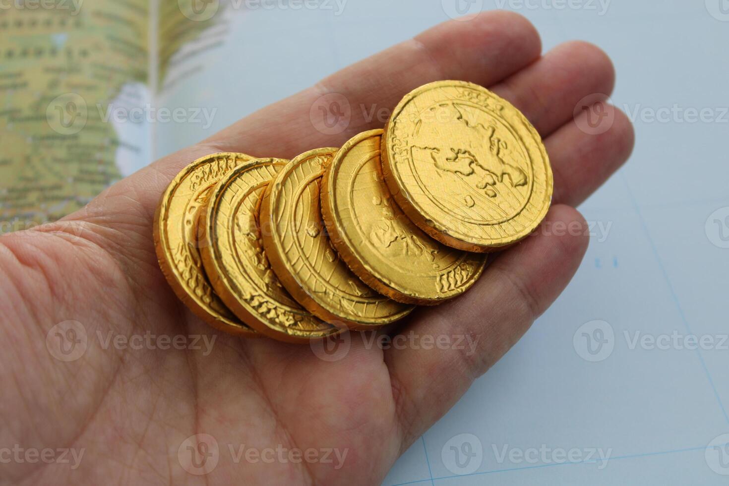 A hand holds a gold coin with the word dragon on it. photo