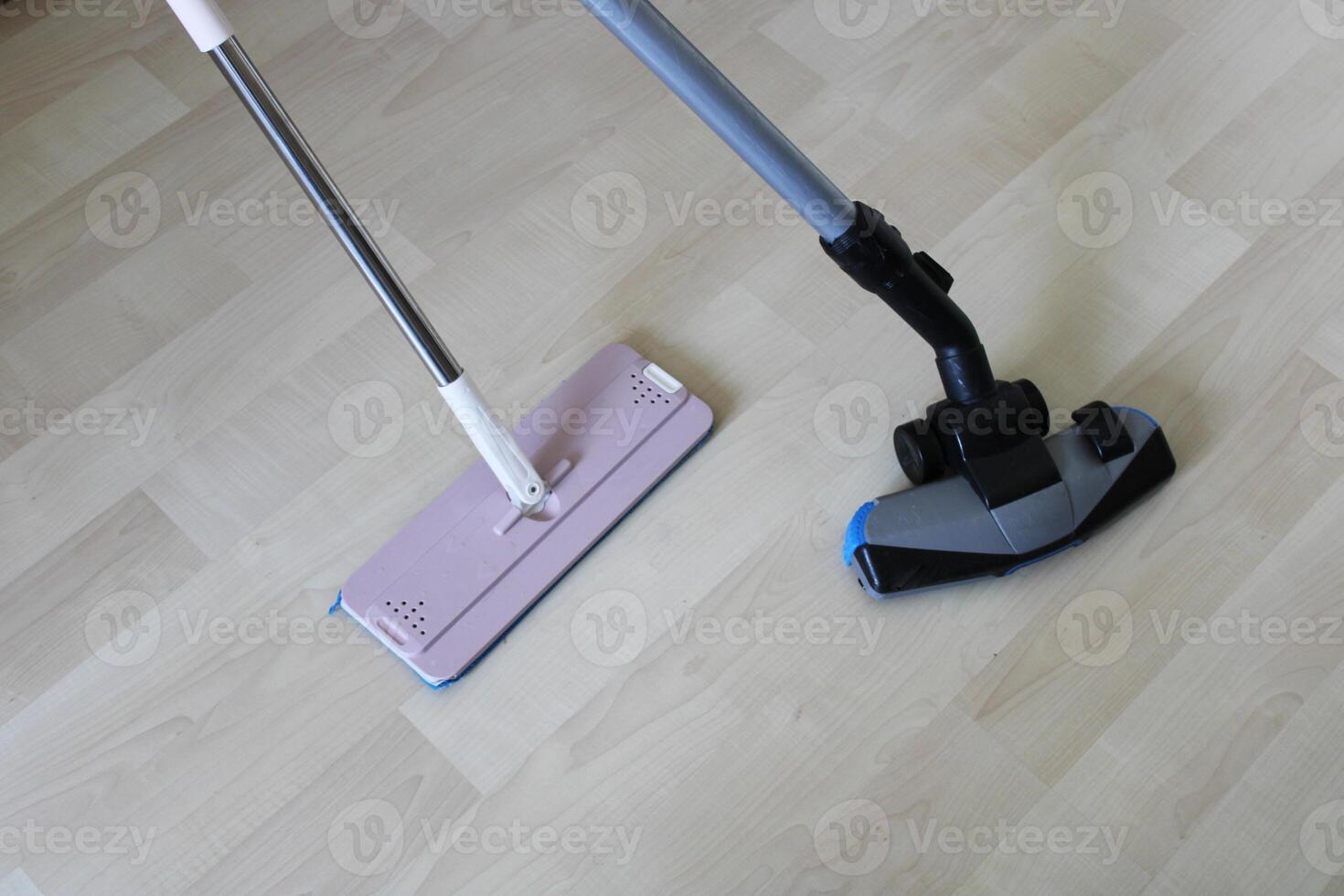 Cleaning material and vacuum cleaner on wooden floor. home cleaning photo