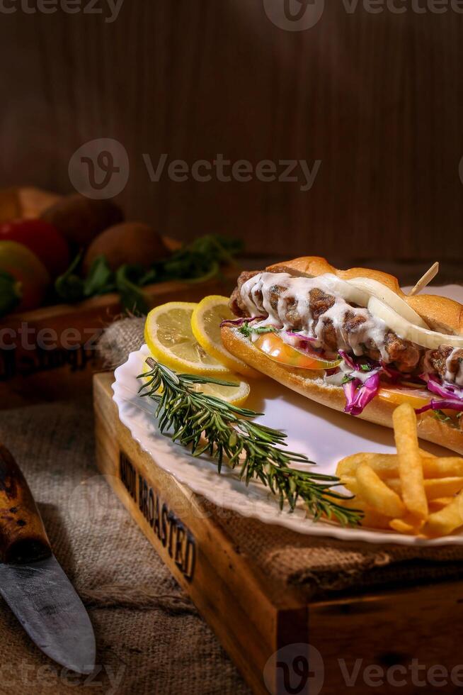 hot dog with french fries and vegetables on a wooden background. selective focus photo