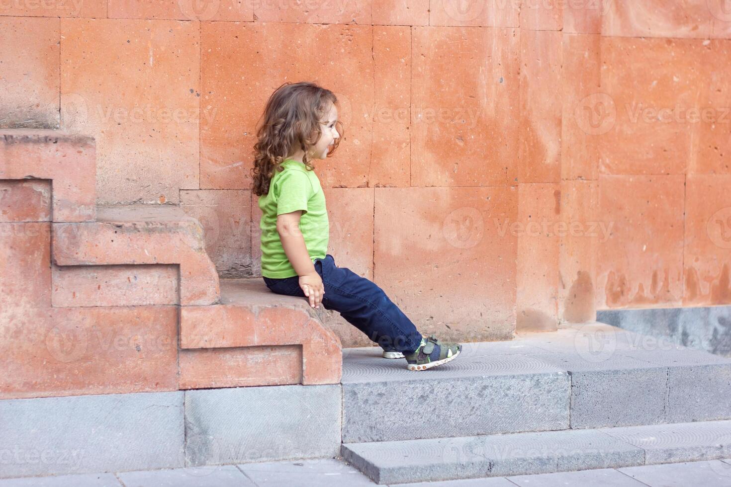 happy little boy playing in the park, long hair boy in the park photo