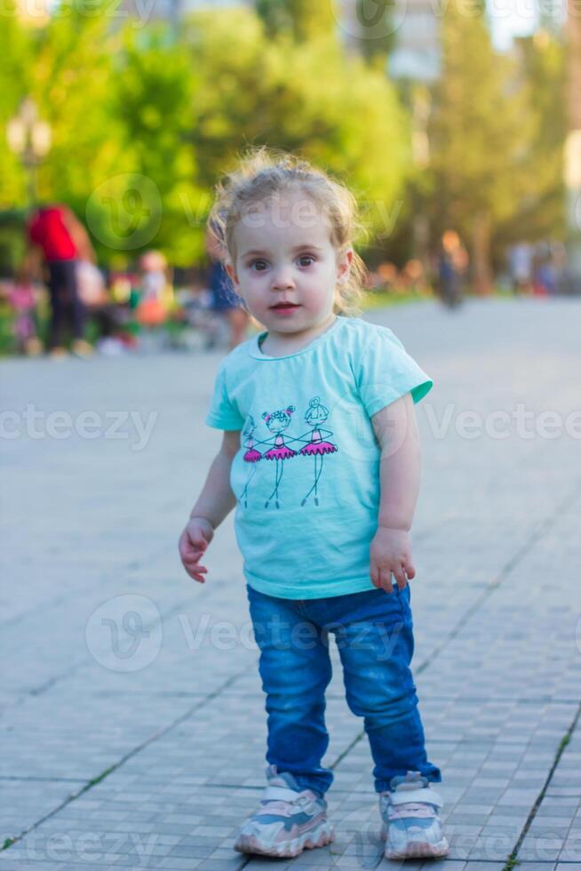 small girl playing in the park photo