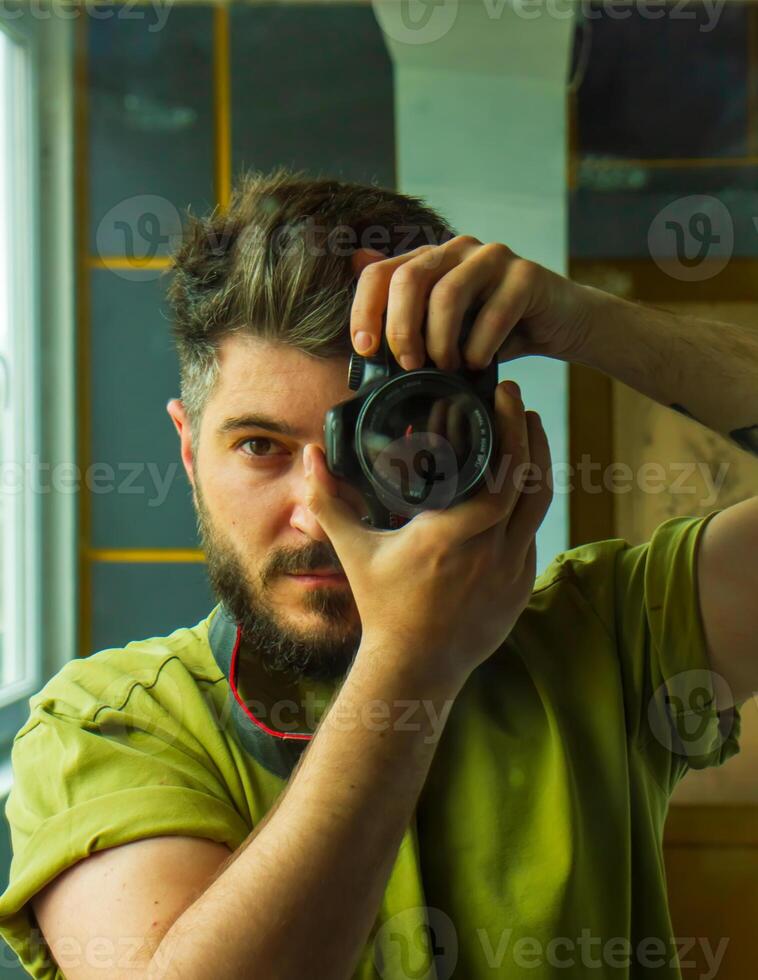 man taking a picture, young man taking a photo, a man with camera, reflection of man in mirror photo