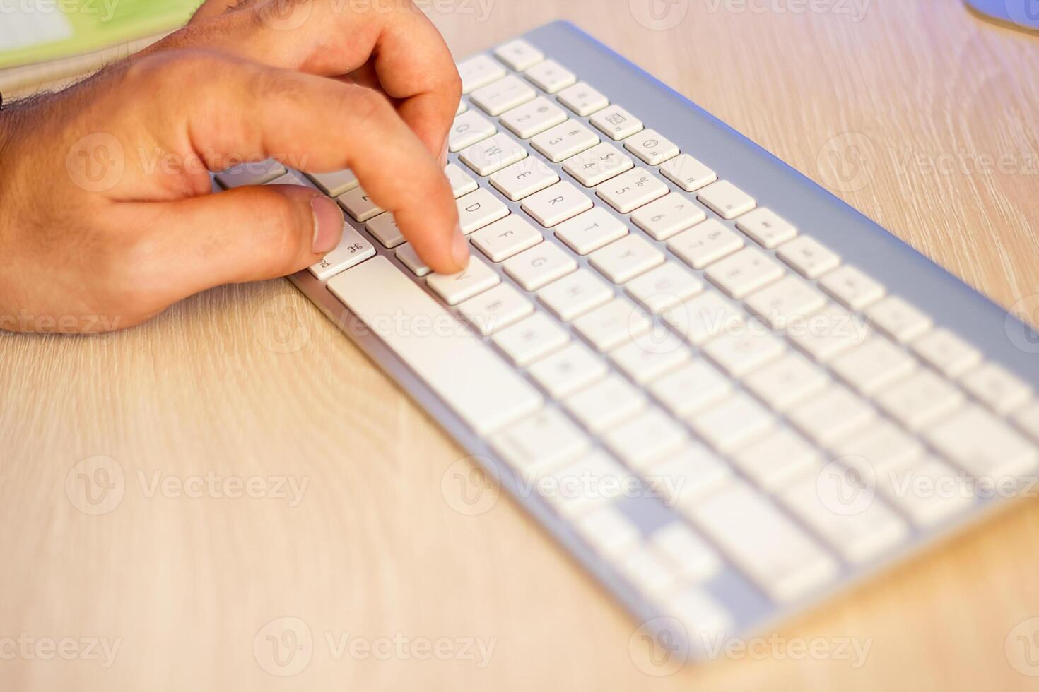 hands typing on a laptop in office photo