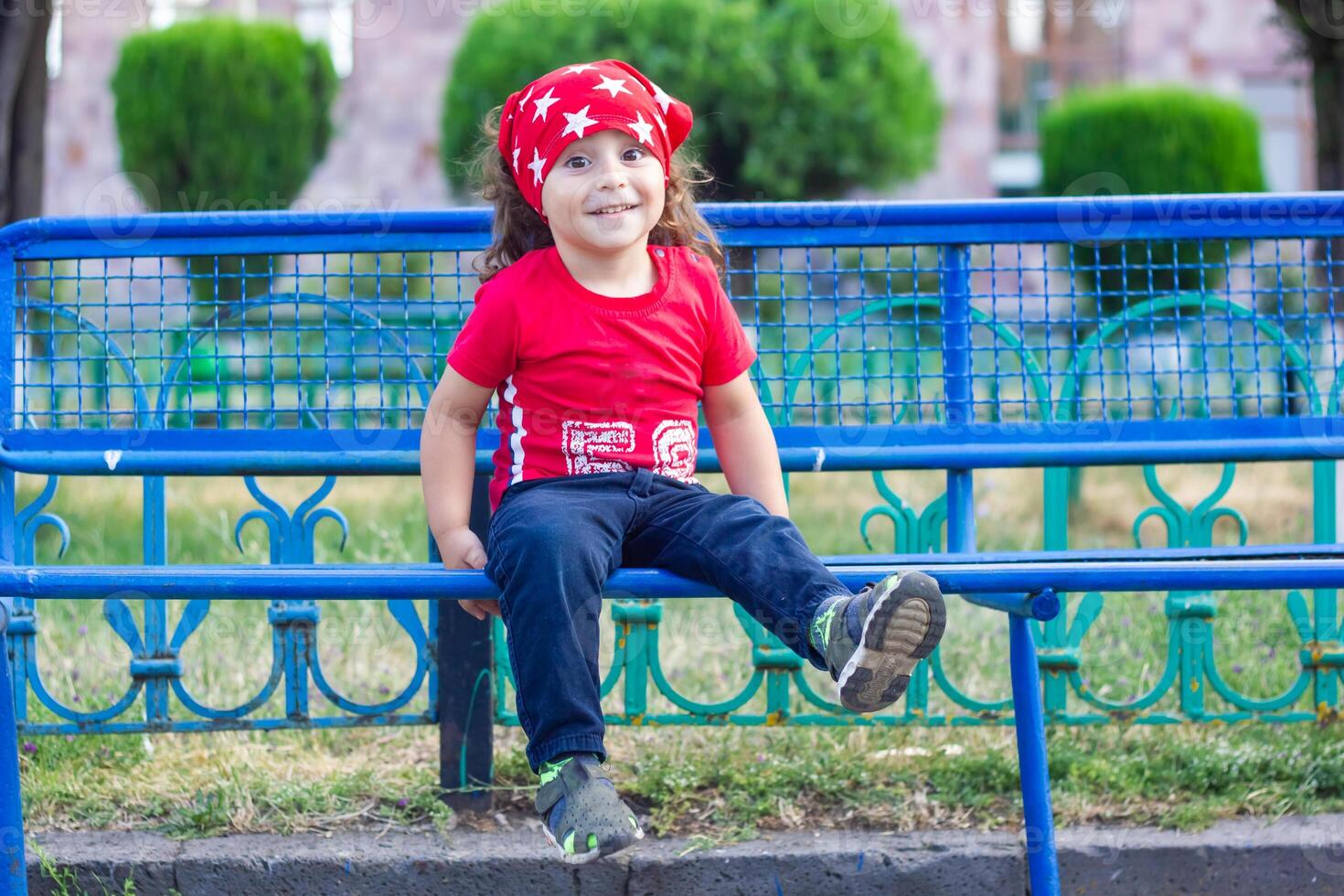 happy little boy playing in the park, long hair boy in the park photo