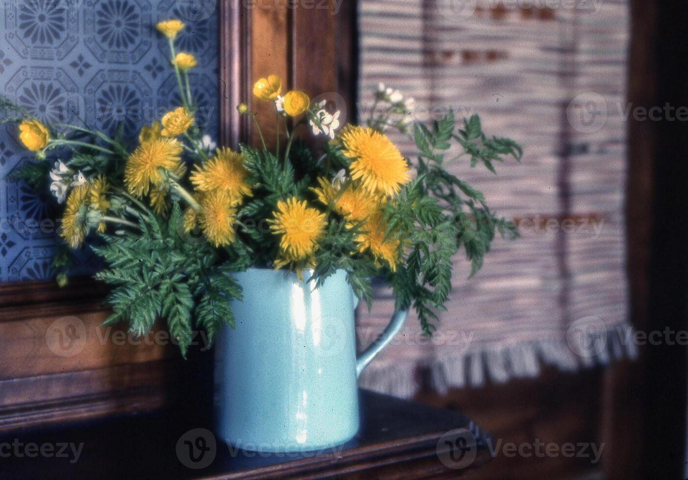 a vase filled with yellow flowers sitting on a table photo