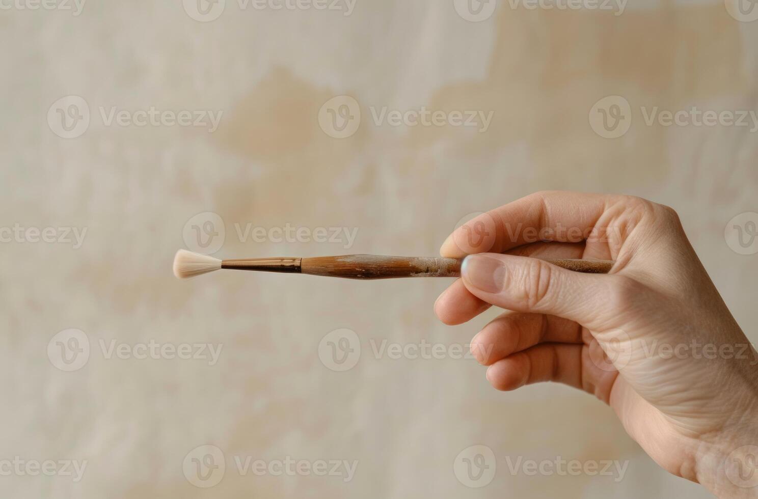 AI generated Hand holding brush ready for painting or creating artwork, world art day artwork photo