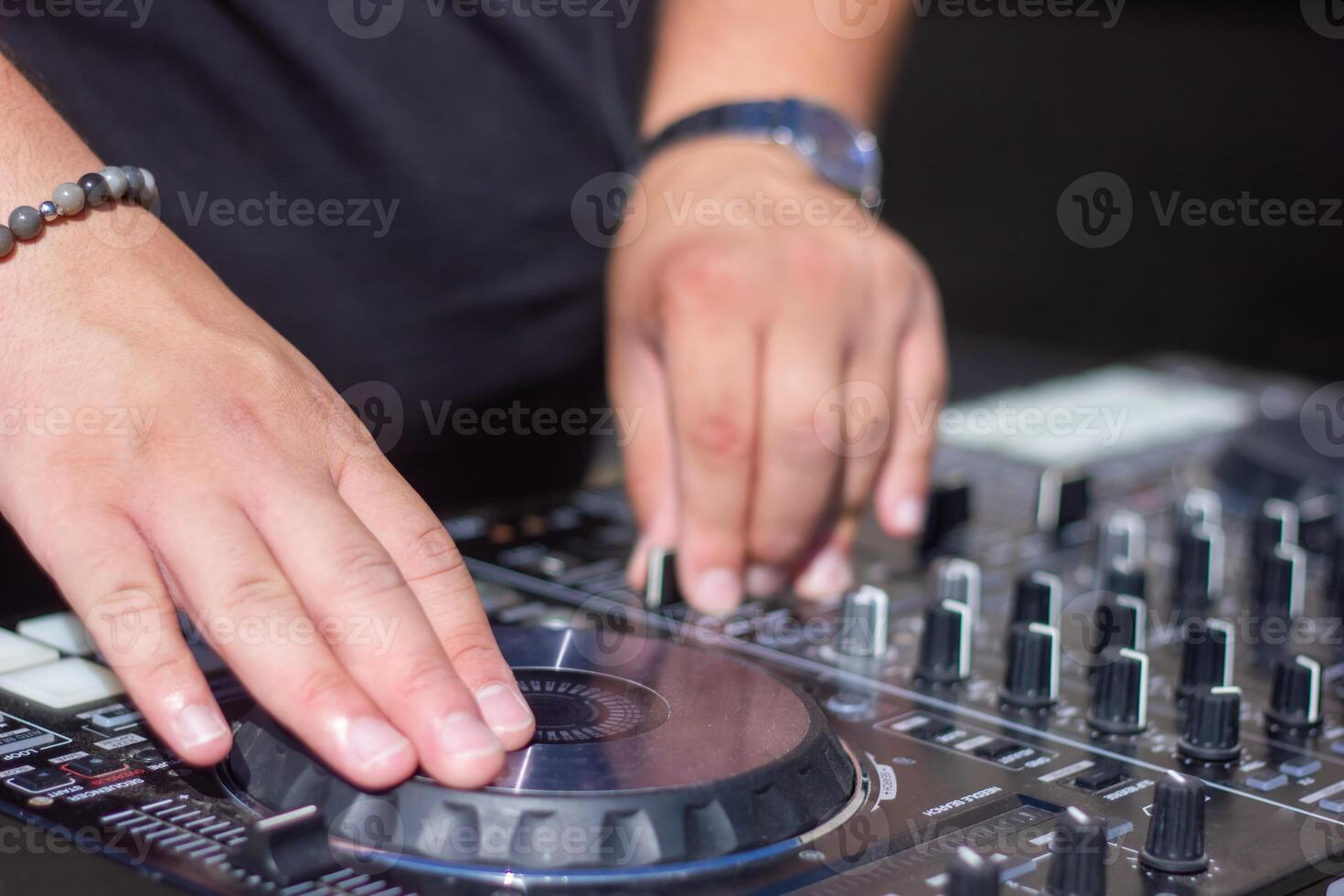 dj with headphones and mixer in the park, the dj at work photo