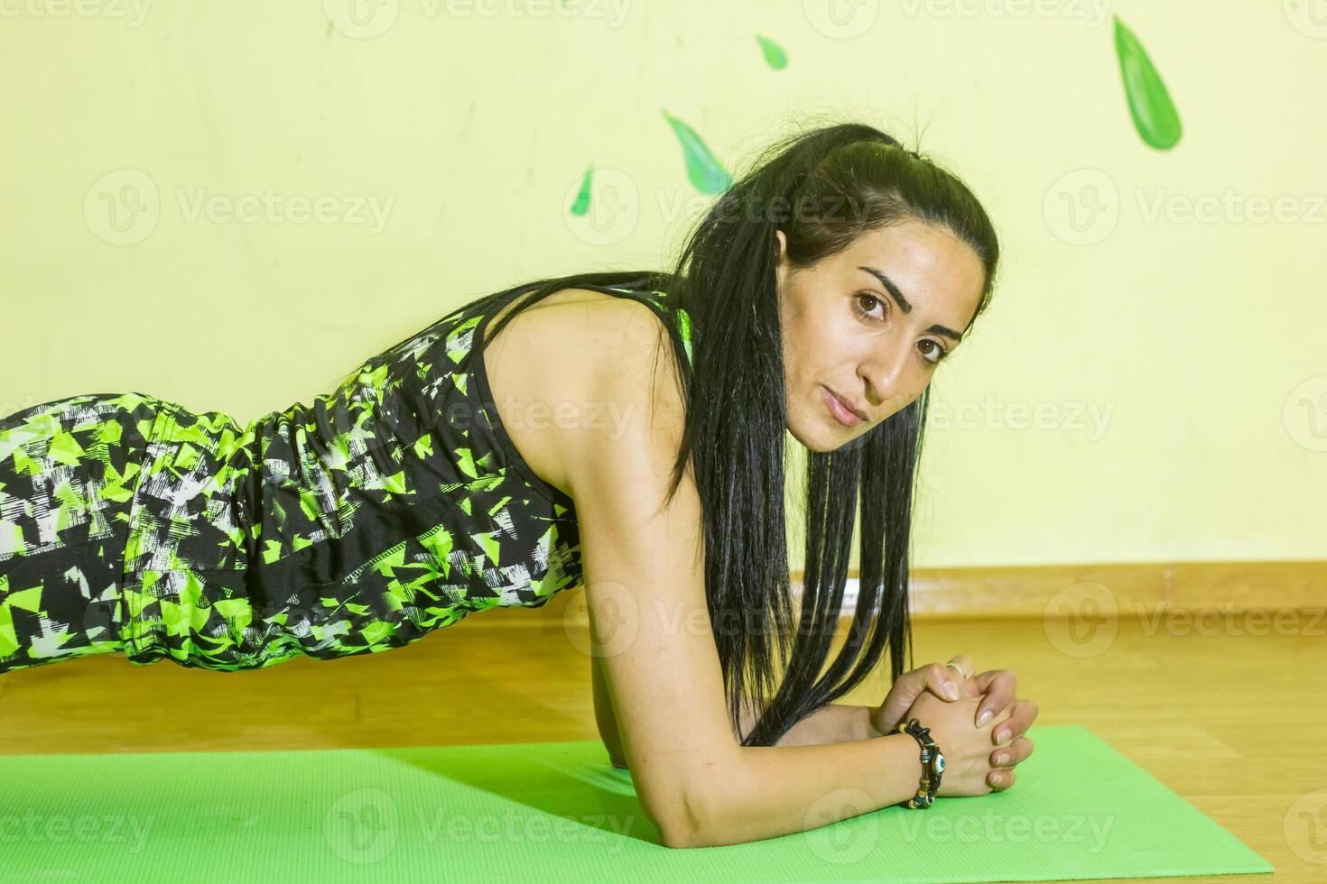 woman doing fitness exercise, young woman doing fitness exercises in fitness club photo