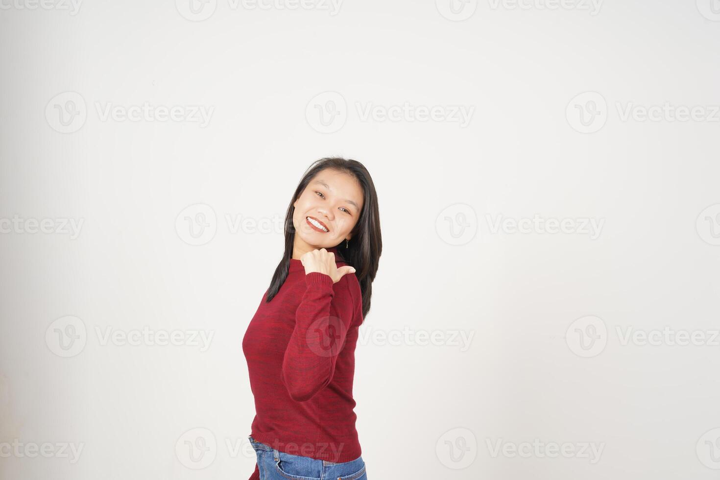 Young Asian woman in Red t-shirt Pointing side at copy space with thumb isolated on white background photo