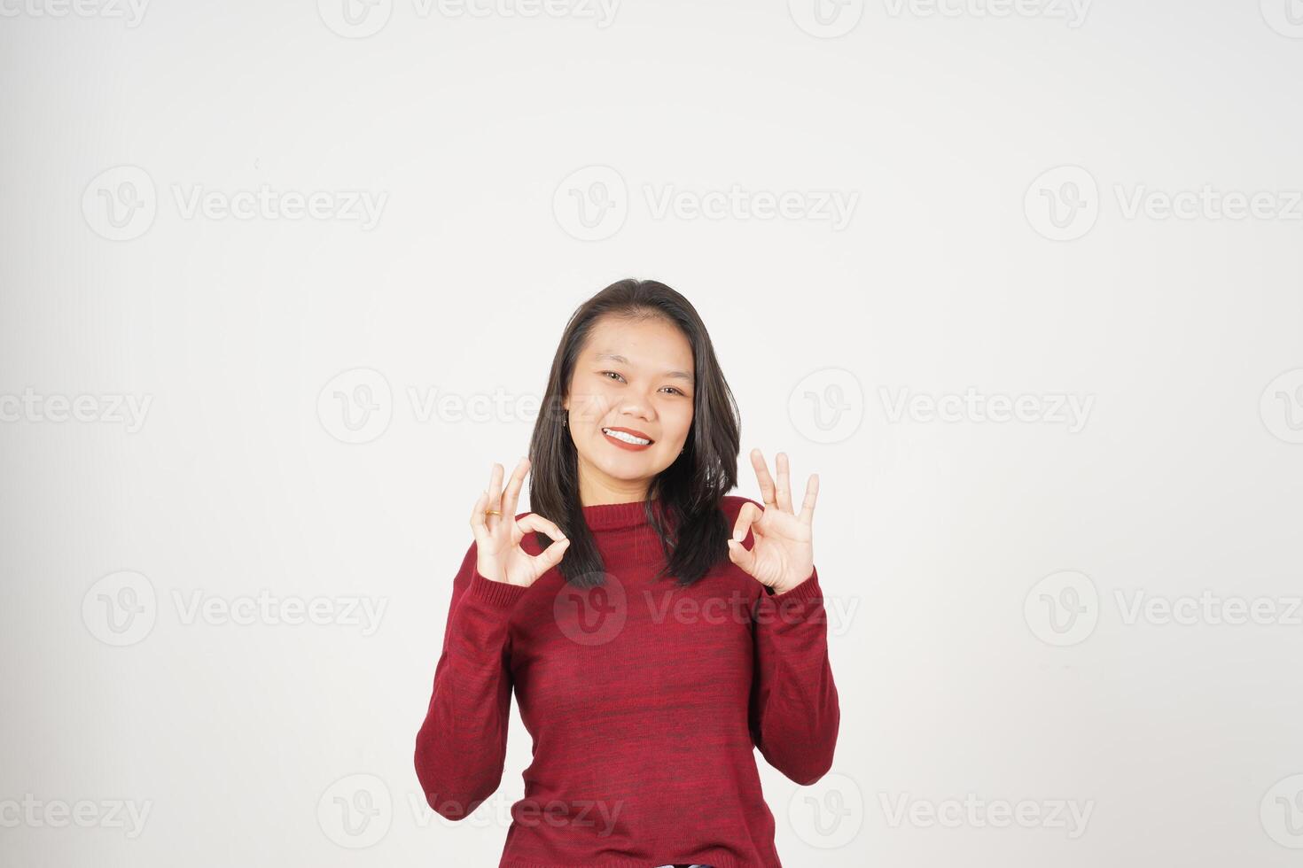 Young Asian woman in Red t-shirt smiling and showing okay sign isolated on white background photo