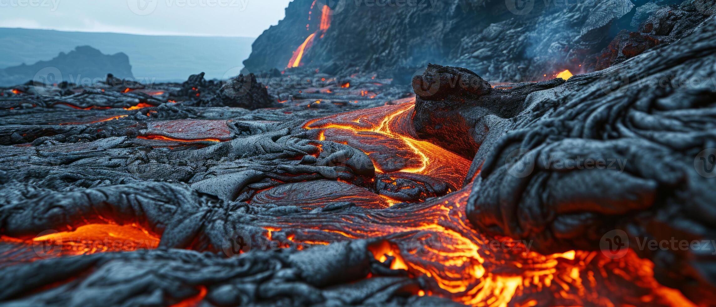 AI generated Molten Lava Flow on Rugged Volcanic Landscape. Fiery molten lava flows through a dark, cooled volcanic terrain, showcasing the raw power of nature photo