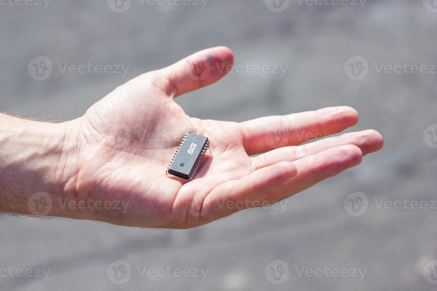 5G chip in hand of a young man photo