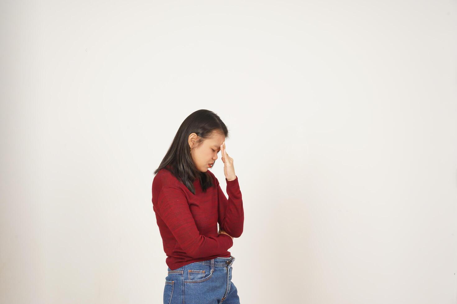 Young Asian woman in Red t-shirt Suffering Headache gesture  isolated on white background photo