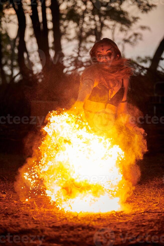 Girl fire dancing performance at outdoor art festival, smooth movements of female artist photo
