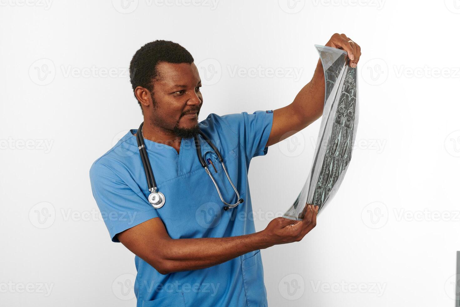 Black surgeon doctor bearded man in blue coat with crossed arms isolated white background copy space photo