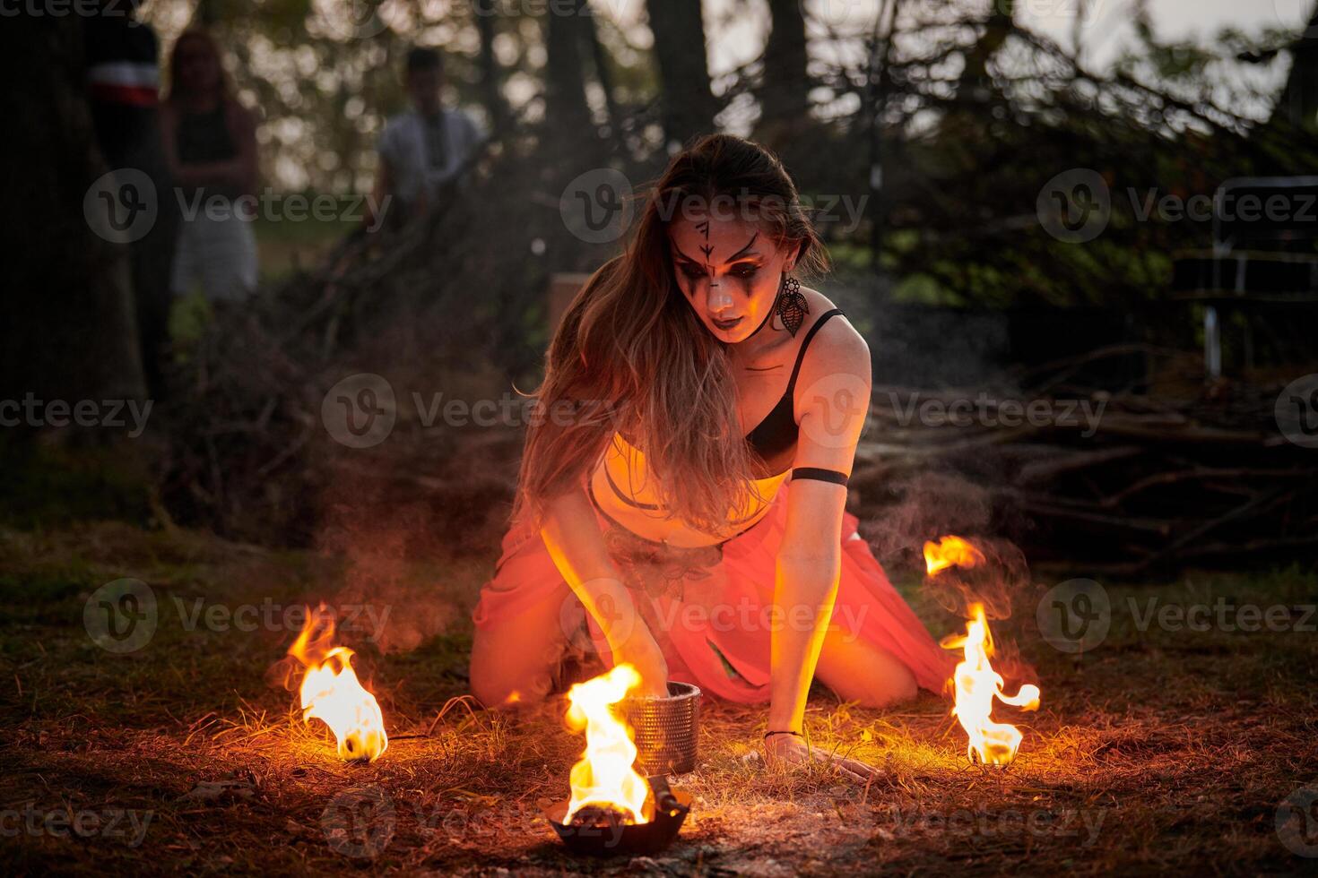 Girl fire dancing performance at outdoor art festival, smooth movements of female artist photo