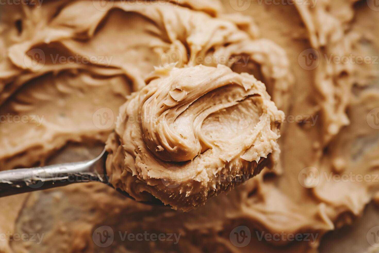 AI generated Creamy peanut butter on a spoon, close-up. photo