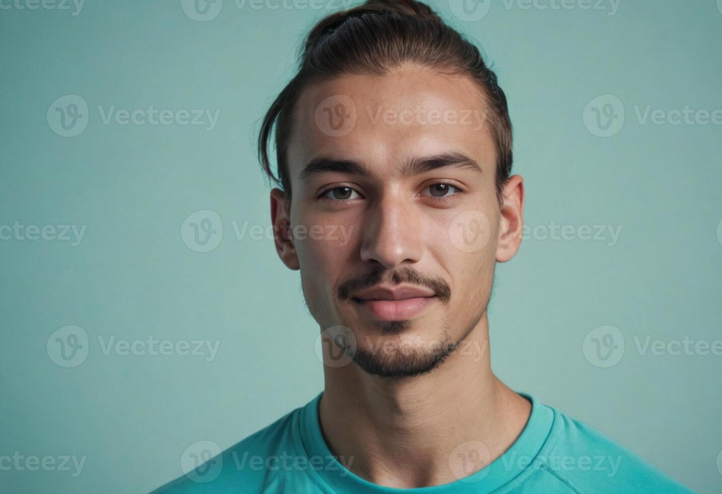 AI Generated A young man with a mustache and teal shirt looks directly at the camera. The background is a soft blue shade. photo