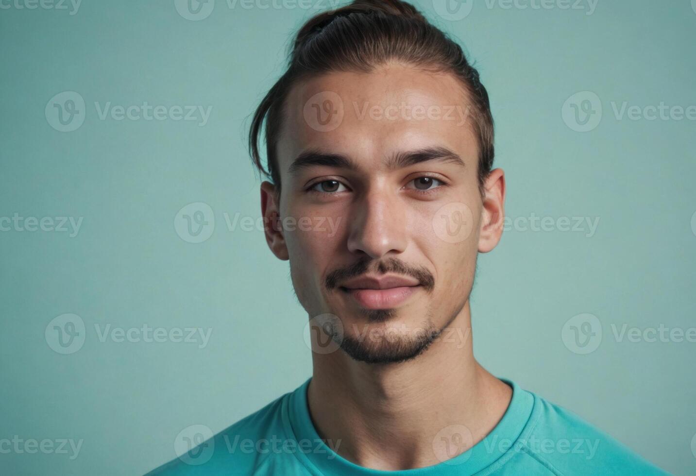 ai generado un joven hombre con un Bigote y verde azulado camisa mira directamente a el cámara. el antecedentes es un suave azul sombra. foto