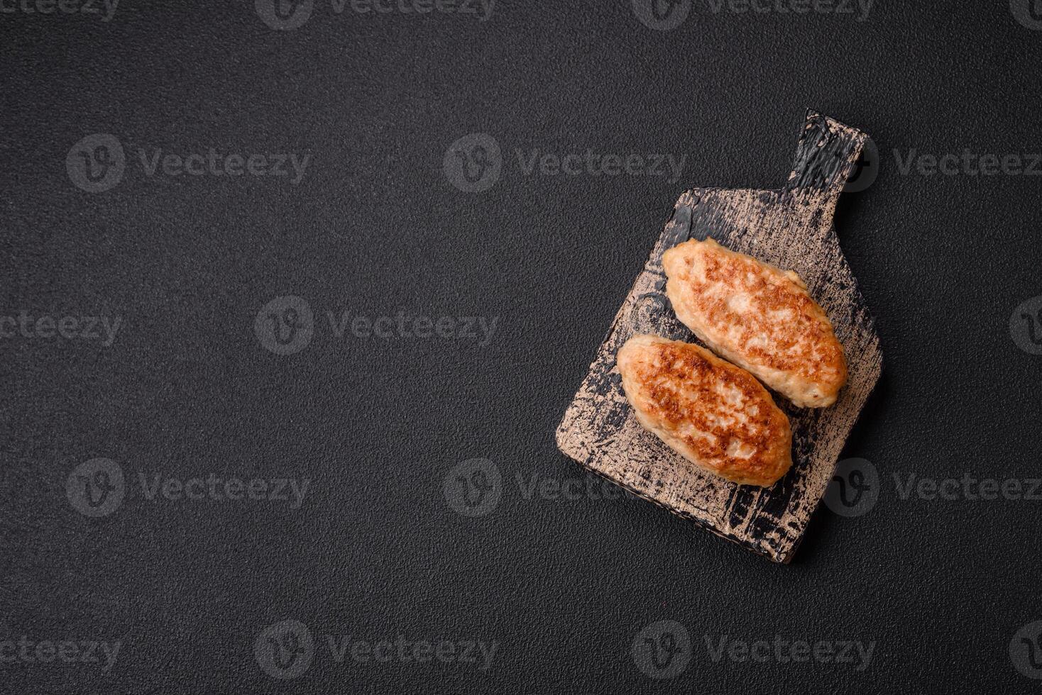 Delicious fresh fried minced fish cutlets with spices and herbs photo