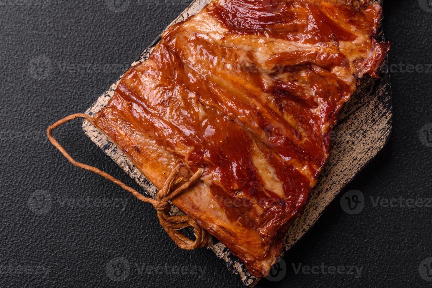 Delicious smoked or grilled ribs with olives, spices and herbs photo