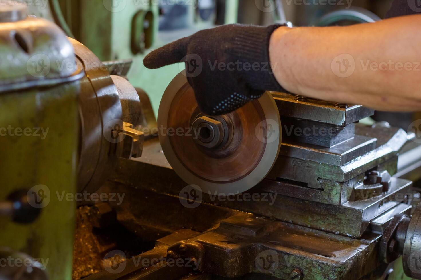 close up of a man using a machine, close up of a man working on a machine photo
