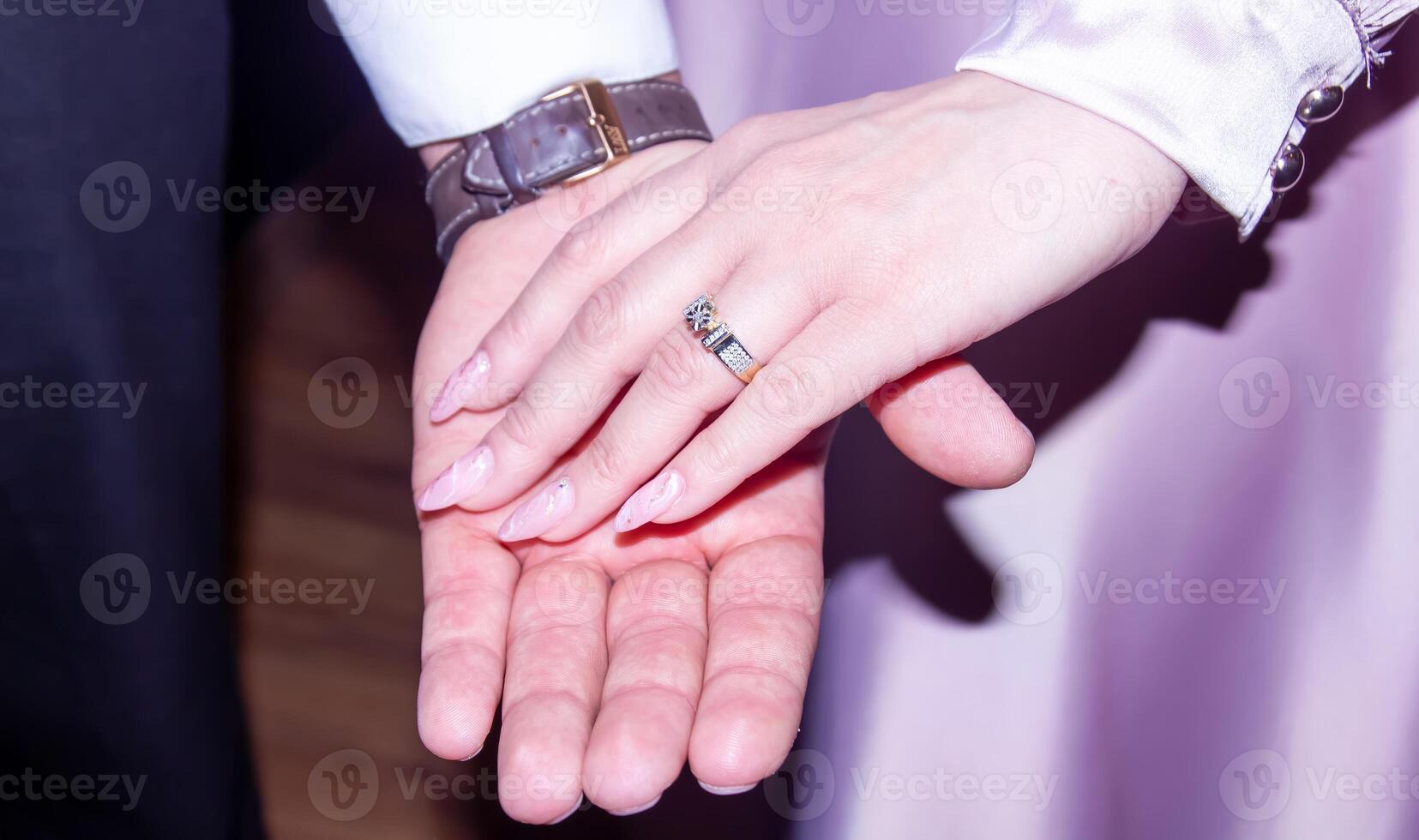 hands of the groom and bride, bride and groom holding hands photo