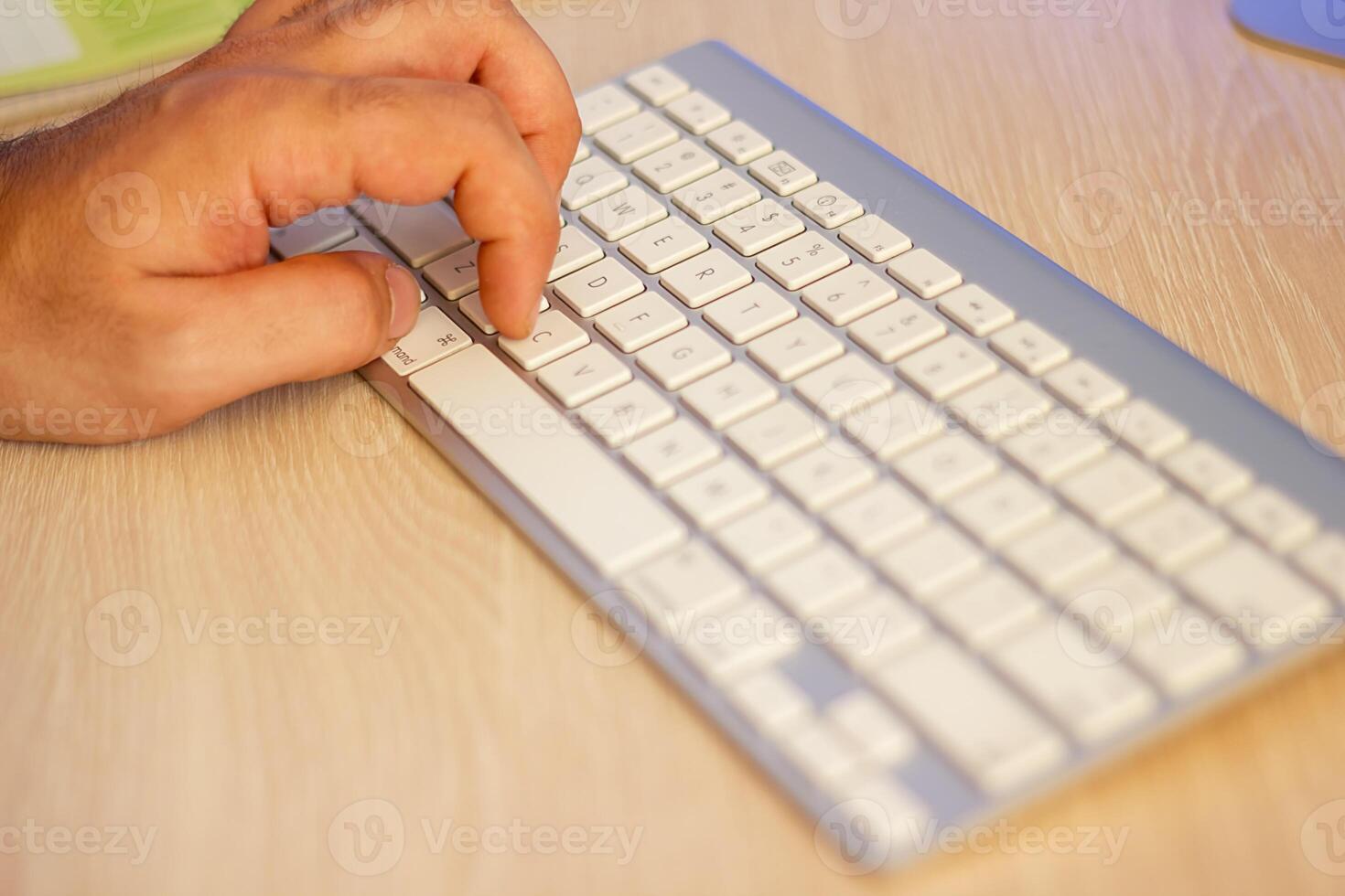 close up of hands typing on a laptop in office photo