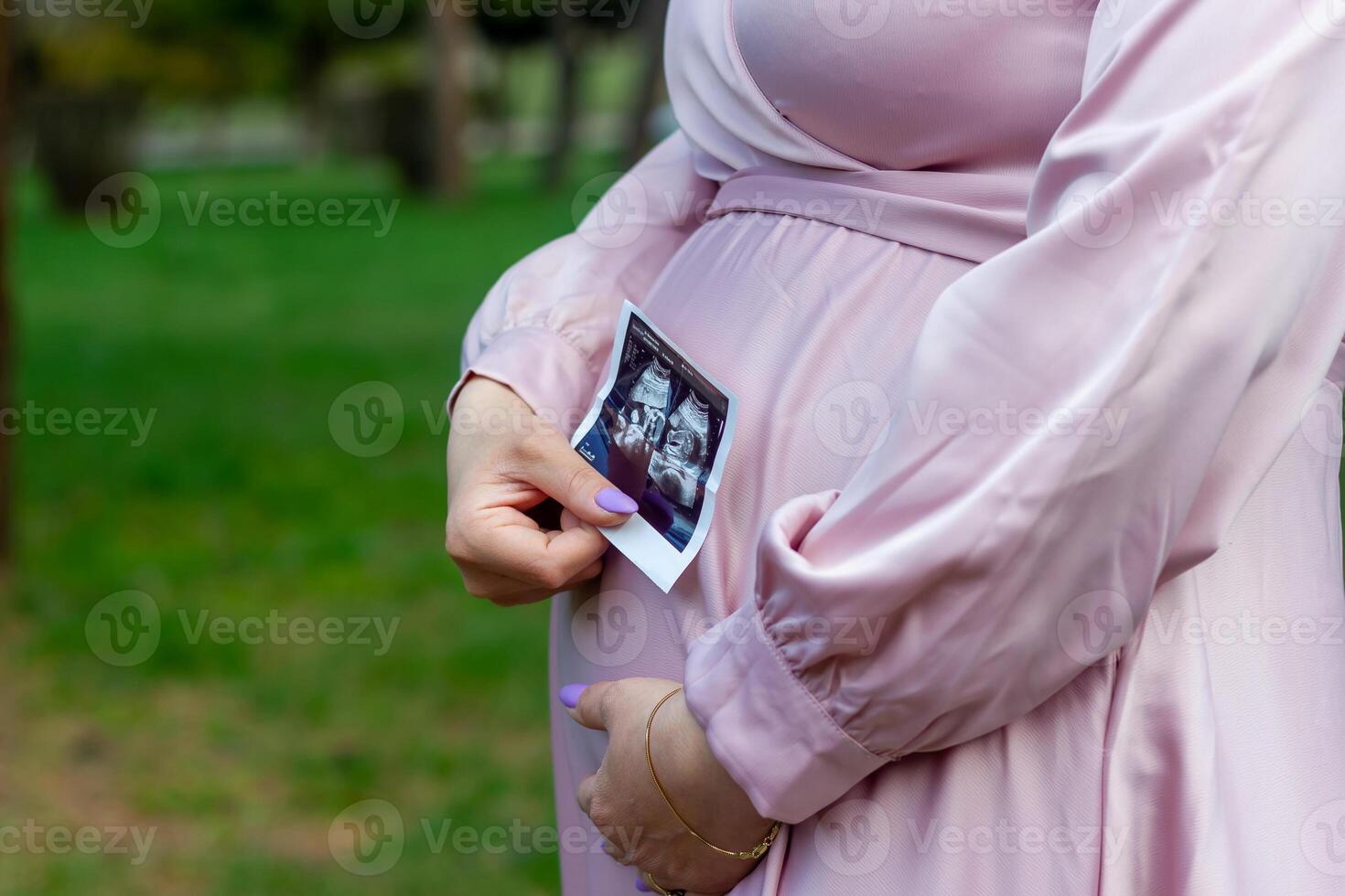 the pregnant woman in the park, beautiful woman in the park, pregnant woman in spring photo