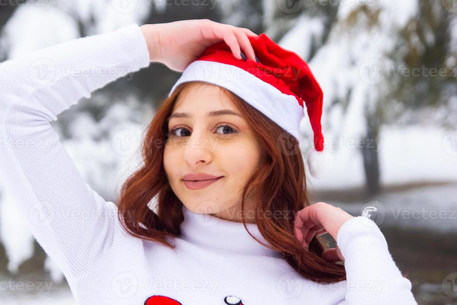 pretty young woman in winter park, red haired girl in the park in winter photo