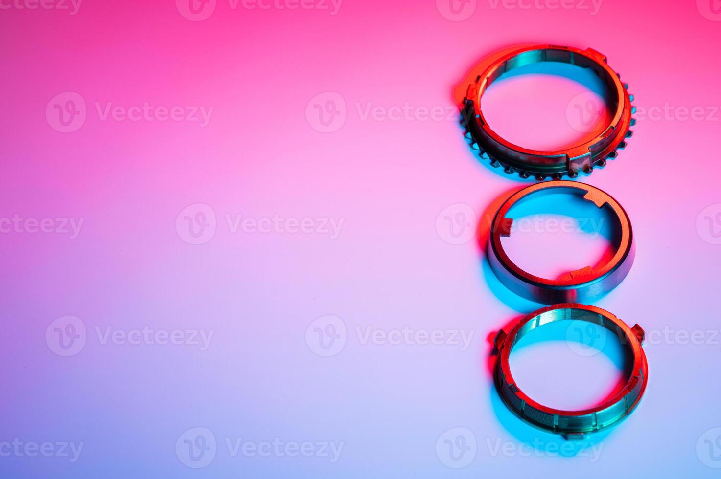 The individual elements of the transmission gear in the gearbox. A new set of synchronizers in brass in blue and red. photo