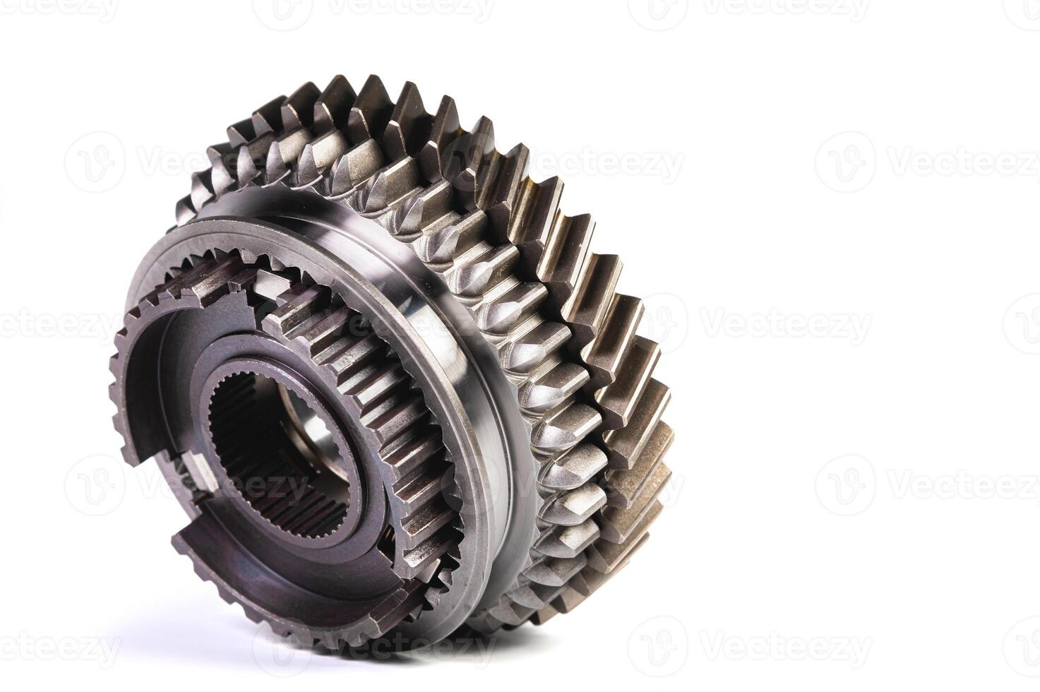 The two new shiny metal gear of the switch box is fronted by a isolated on white background. The concept of new spare parts for car maintenance and repair photo