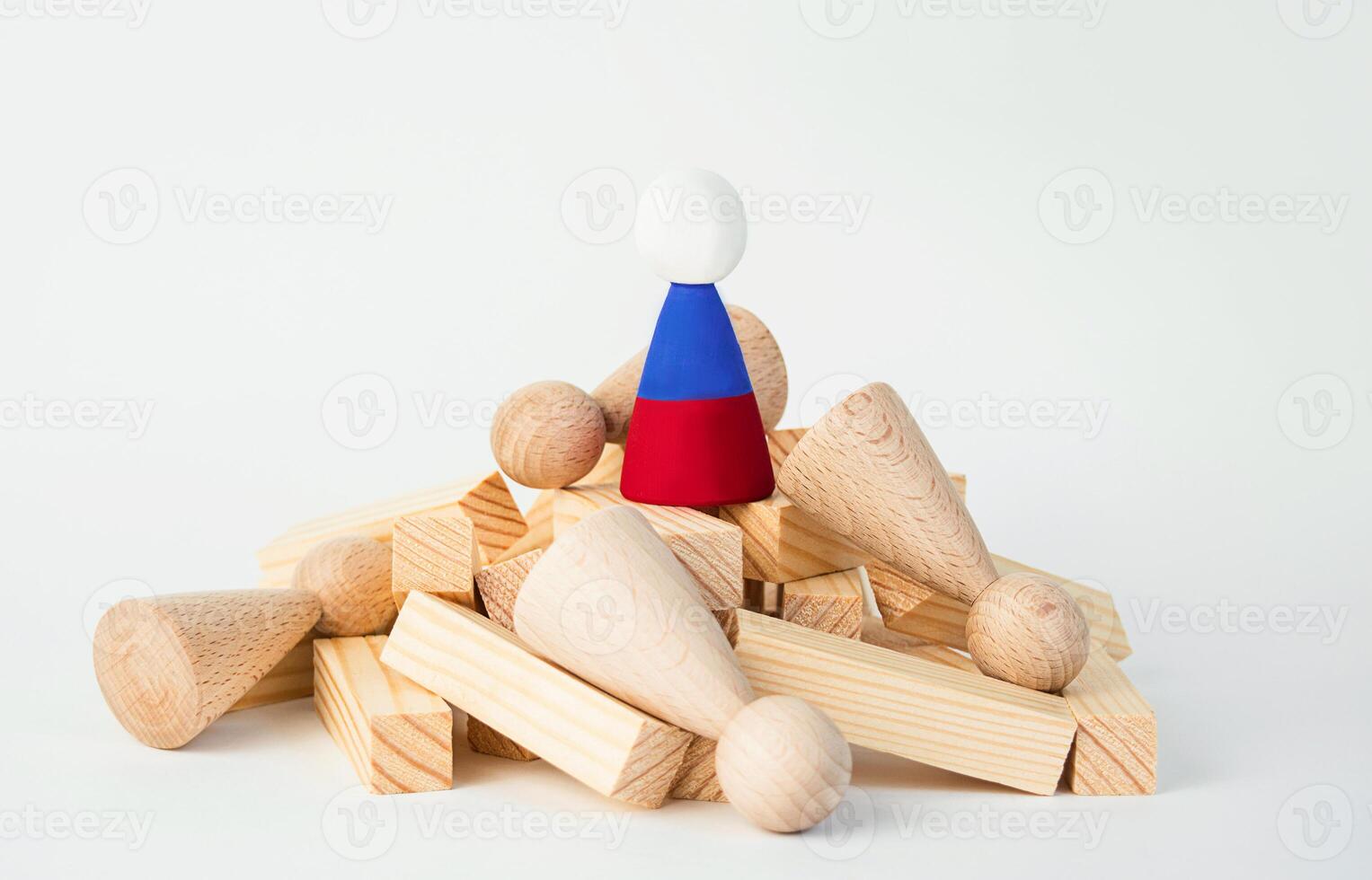 The concept of the fall of the Russian economy. A wooden man with the symbol of the Russian flag stands on a ruined mountain. The Russian leader stands on the heads of his people. photo