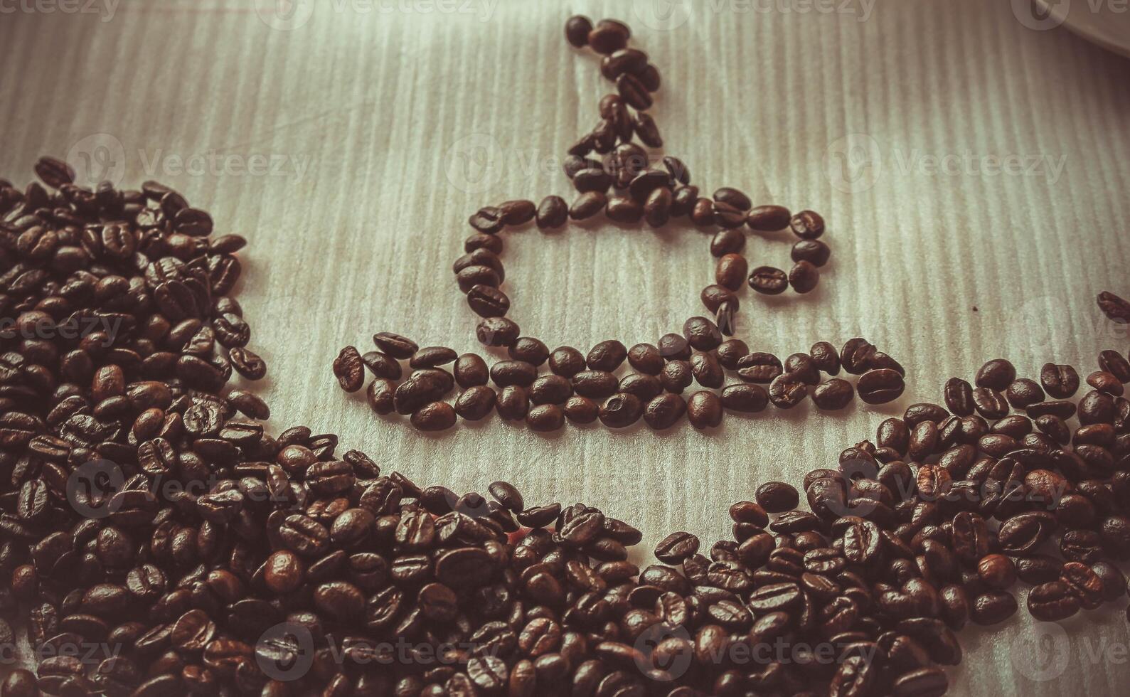 Coffee beans on wooden table with filter effect retro vintage style photo