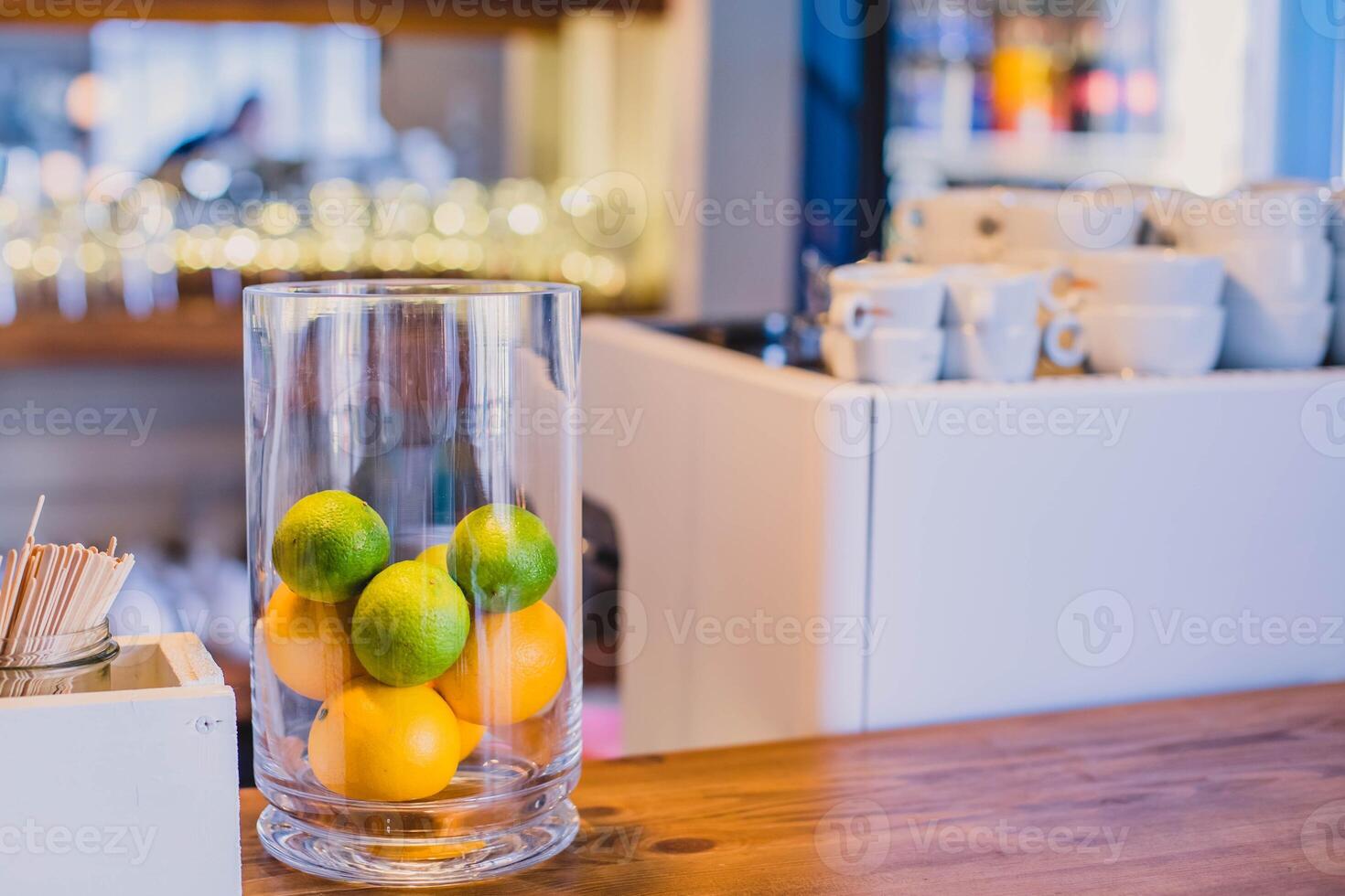 Lemon and lime in glass on table in coffee shop, stock photo
