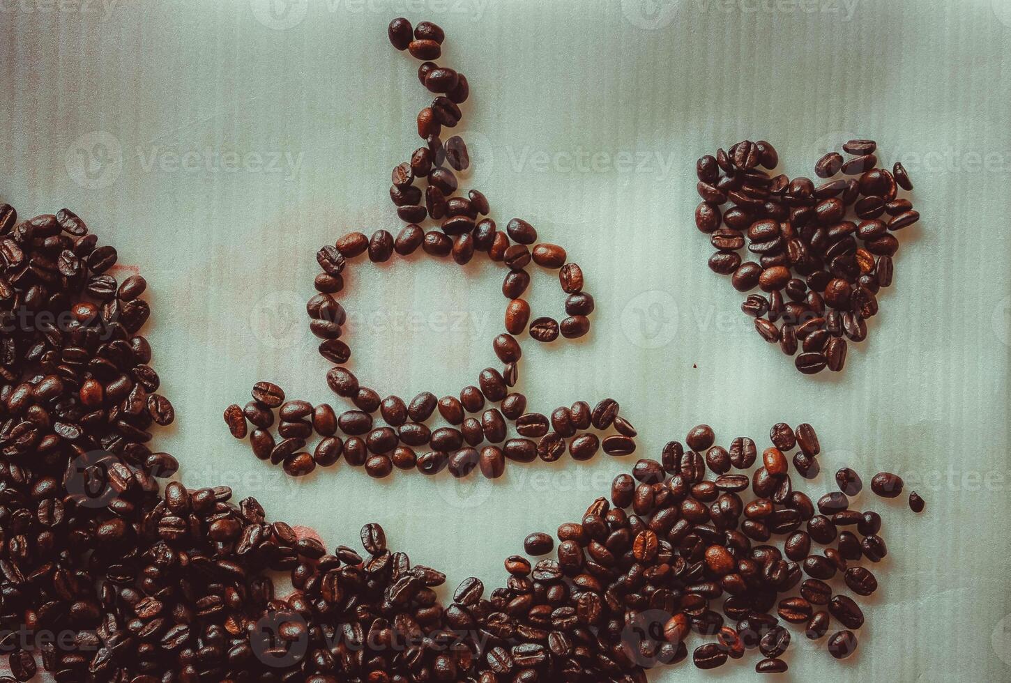 Coffee beans and heart shape on white background, retro toned photo