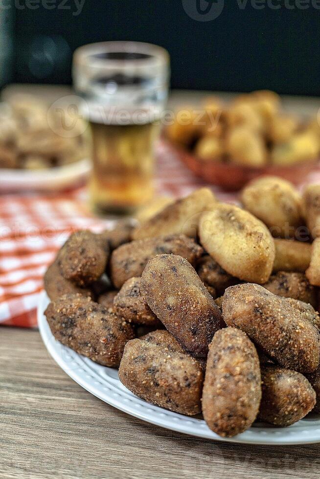 Fried breadcrumbs on a plate with a glass of beer photo