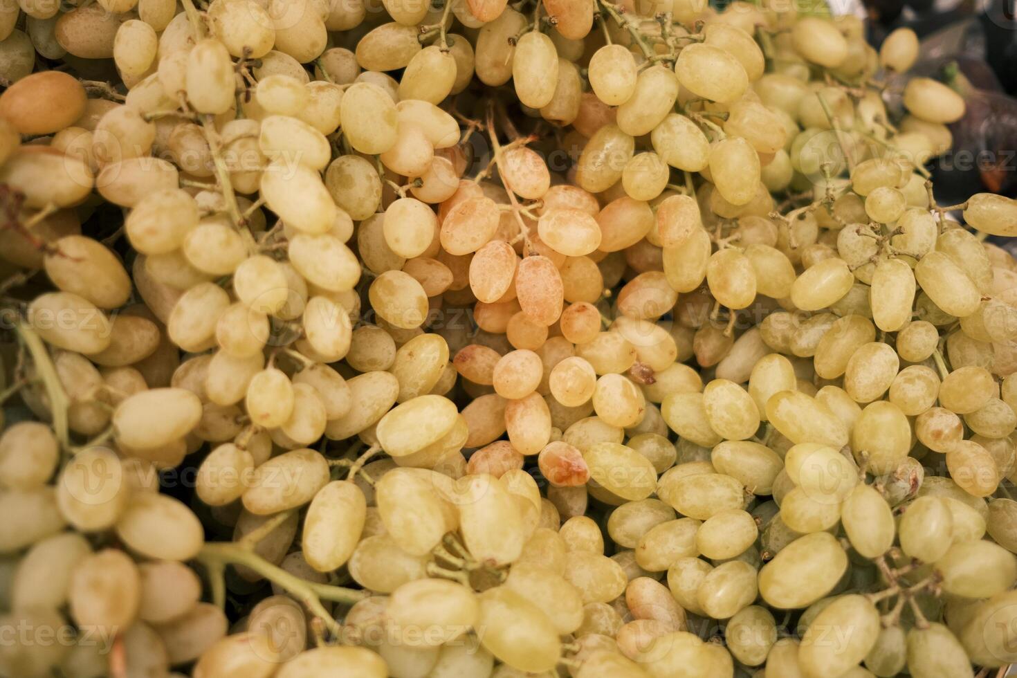 Bunch of ripe grapes on a market stall, close-up photo