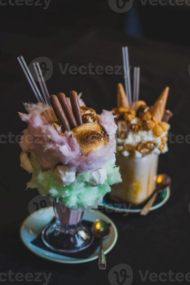 Ice cream with waffle cones and whipped cream in a glass cup photo