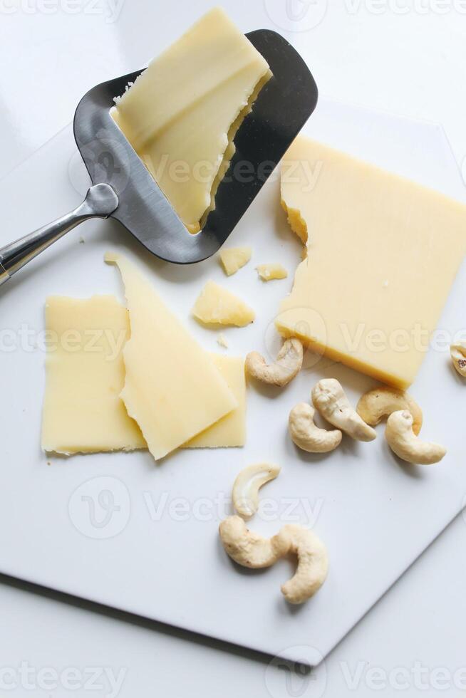 Cheese collection, pieces of hard parmesan cheese with cashew nuts photo